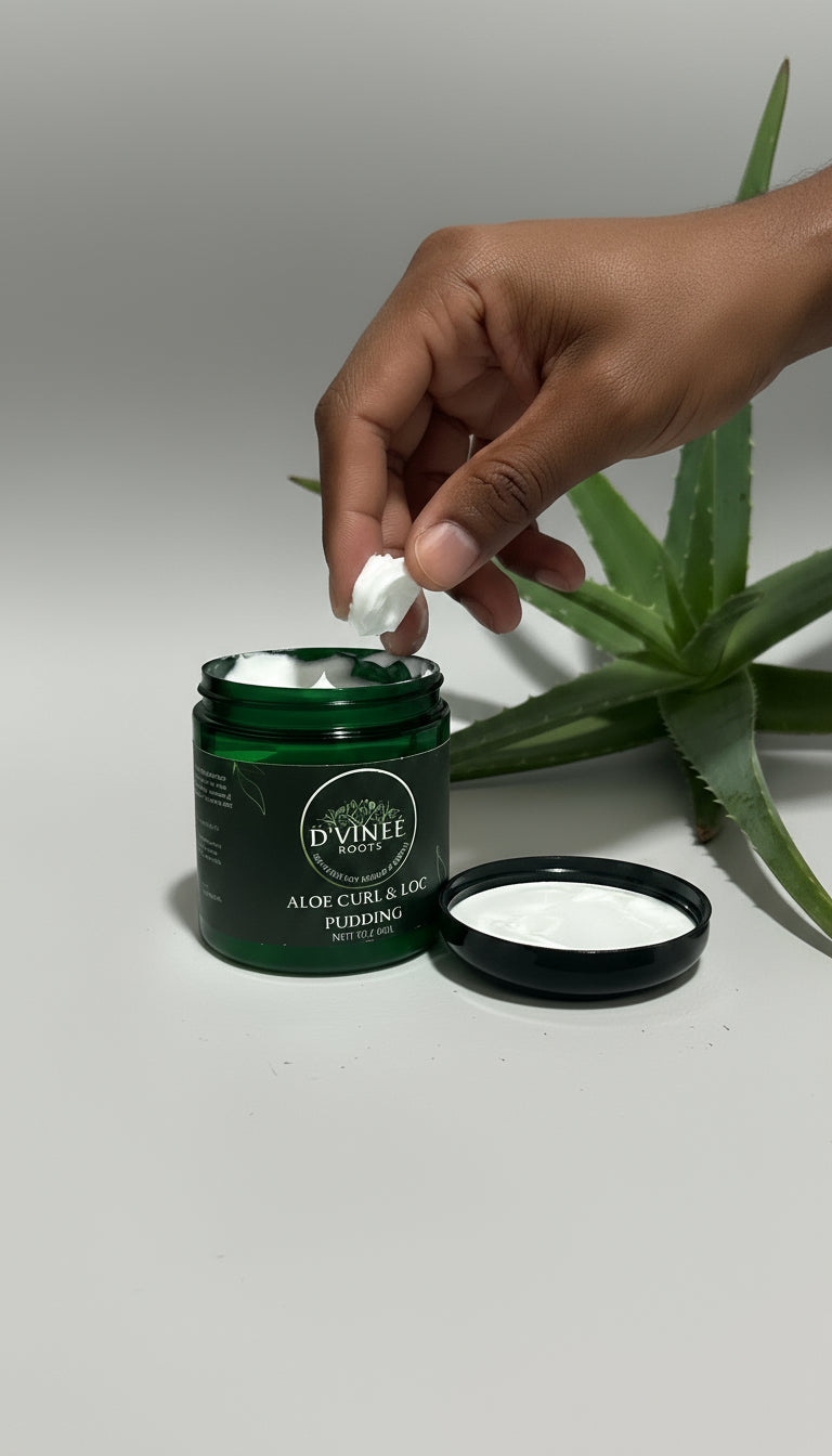 Green jar of D'Vinee Aloe Curl & Lock Pudding on a white surface